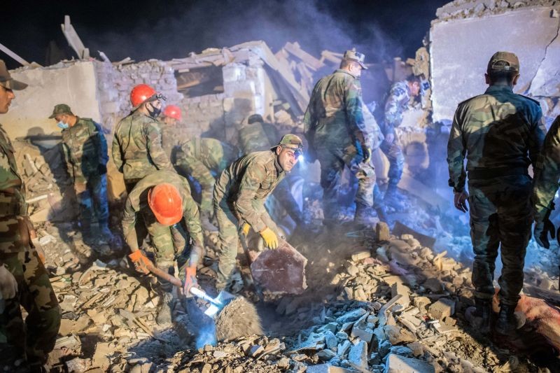 Rescue teams sift through rubble at a site hit by a missile strike during fighting over the breakaway region of Nagorno-Karabakh, in the city of Ganja, Azerbaijan early on October 17, 2020. A missile strike levelled several homes in Azerbaijan's second city of Ganja on October 17, with one resident telling AFP he saw seven victims pulled out of the rubble. (Photo by Bulent Kilic/AFP Photo)